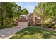 Lovely two-story brick house surrounded by lush greenery and a well-maintained lawn at 2221 Dungiven Ct, Garner, NC 27529
