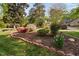 Well-maintained front yard with colorful azaleas, mulch beds, and mature trees at 2221 Dungiven Ct, Garner, NC 27529