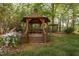 Charming gazebo surrounded by landscaped gardens and lush greenery at 2221 Dungiven Ct, Garner, NC 27529