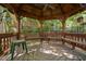 Interior view of the gazebo, featuring a wooden swing, benches, and a ceiling fan at 2221 Dungiven Ct, Garner, NC 27529
