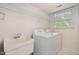 Bright laundry room with white washer, dryer and utility sink at 2221 Dungiven Ct, Garner, NC 27529