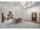 Bright, airy living room with a fireplace, high ceilings, and a decorative front door at 2221 Dungiven Ct, Garner, NC 27529