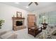 Comfortable living room features a brick fireplace, wood accents, and bright natural light at 2221 Dungiven Ct, Garner, NC 27529