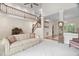 Open living area features a wooden staircase, a grandfather clock, and neutral carpeting at 2221 Dungiven Ct, Garner, NC 27529