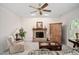 Cozy living room featuring a brick fireplace, ceiling fan, and comfortable seating at 2221 Dungiven Ct, Garner, NC 27529