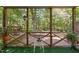 Enclosed porch with view of deck and fenced backyard at 2221 Dungiven Ct, Garner, NC 27529