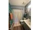 Stylish bathroom featuring unique leaf-print wallpaper and a shower with decorative curtain at 26 Stonewall Way, Durham, NC 27704