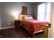 Cozy bedroom with natural light from a window, light grey walls, and wood-look floors at 26 Stonewall Way, Durham, NC 27704