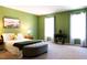 Bright bedroom with two windows, green walls, and a stylish, comfy aesthetic at 26 Stonewall Way, Durham, NC 27704