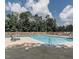 Community pool surrounded by lounge chairs and a fence, with trees in the background at 26 Stonewall Way, Durham, NC 27704