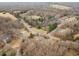 Overhead view of a home, a road, and wooded areas in a rural residential neighborhood at 2670 Turner Rd, Mebane, NC 27302