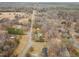 Aerial view of a community surrounded by trees and open space with a road running through it at 2670 Turner Rd, Mebane, NC 27302
