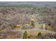 An aerial view of the property showcasing its location within a wooded neighborhood at 2670 Turner Rd, Mebane, NC 27302