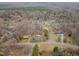 An aerial view of the property showcasing its location within a wooded neighborhood at 2670 Turner Rd, Mebane, NC 27302