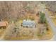 Overhead view of a home, wooded area, a road, and a storage shed in a residential neighborhood at 2670 Turner Rd, Mebane, NC 27302