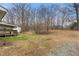 View of the home's backyard featuring a small storage shed and a dormant lawn at 2670 Turner Rd, Mebane, NC 27302