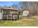 View of the home's backyard, which features a storage shed, the house, and the deck at 2670 Turner Rd, Mebane, NC 27302