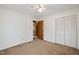 Large bedroom with neutral carpet, ceiling fan and light, and double-door closet at 2670 Turner Rd, Mebane, NC 27302