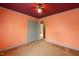 Bedroom with orange walls, red ceiling, neutral carpet, and a closet with gray doors at 2670 Turner Rd, Mebane, NC 27302