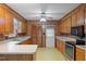 Traditional kitchen with wood cabinets, laminate countertops, and vintage yellow pattern flooring at 2670 Turner Rd, Mebane, NC 27302