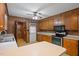 Traditional kitchen with wood cabinets, laminate countertops, and vintage yellow pattern flooring at 2670 Turner Rd, Mebane, NC 27302