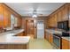 Traditional kitchen with wood cabinets, laminate countertops, and vintage yellow pattern flooring at 2670 Turner Rd, Mebane, NC 27302