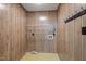 Laundry room featuring wood paneling, a vintage yellow pattern floor, and wire rack shelving at 2670 Turner Rd, Mebane, NC 27302