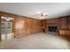 Spacious living room with a brick fireplace, built-in shelving, and a view to the back deck at 2670 Turner Rd, Mebane, NC 27302