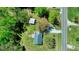 Aerial view of a home with a metal roof, adjacent to a road, featuring a detached garage and ample yard space at 2700 Chub Lake Rd, Roxboro, NC 27574