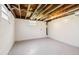 Unfinished basement featuring painted walls, painted floors, and exposed ductwork, ready for your vision at 2700 Chub Lake Rd, Roxboro, NC 27574