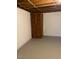 Spacious basement with painted walls, exposed ceiling, and wooden closet for additional storage at 2700 Chub Lake Rd, Roxboro, NC 27574