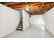 Unfinished basement with exposed beams and painted walls, presenting a blank canvas for customization at 2700 Chub Lake Rd, Roxboro, NC 27574