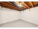 Unfinished basement ready for your vision featuring painted floors, walls, and exposed ductwork and ceiling at 2700 Chub Lake Rd, Roxboro, NC 27574