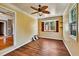 Bright bedroom featuring hardwood floors, a ceiling fan, and a cozy window nook perfect for relaxation at 2700 Chub Lake Rd, Roxboro, NC 27574