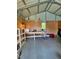 Outbuilding featuring interior open floorplan, shelving, and work tables providing ample storage or workspace at 2700 Chub Lake Rd, Roxboro, NC 27574