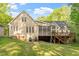 Spacious backyard features a deck, screened porch, and mature trees at 2900 Old Trafford Way, Raleigh, NC 27606