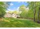 Large backyard surrounded by lush greenery and mature trees at 2900 Old Trafford Way, Raleigh, NC 27606