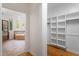 View of the bathroom with tub and a walk in closet with shelves at 2900 Old Trafford Way, Raleigh, NC 27606