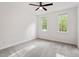 Bedroom with neutral carpet, a ceiling fan, and two windows providing natural light at 2900 Old Trafford Way, Raleigh, NC 27606