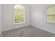 Empty bedroom with neutral carpet and two windows for natural light at 2900 Old Trafford Way, Raleigh, NC 27606