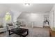 Bright bonus room with neutral carpet, comfortable seating and natural light from the arched window at 2900 Old Trafford Way, Raleigh, NC 27606