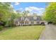 Beautifully landscaped front yard with a traditional-style home and attached garage at 2900 Old Trafford Way, Raleigh, NC 27606