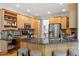 Spacious eat-in kitchen featuring stainless steel appliances, granite countertops, and custom wood cabinetry at 2900 Old Trafford Way, Raleigh, NC 27606
