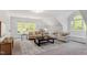 Living room with multiple couches and windows, and a dark wood coffee table at 2900 Old Trafford Way, Raleigh, NC 27606