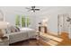 Bright main bedroom featuring hardwood floors, tray ceiling, and plenty of natural light at 2900 Old Trafford Way, Raleigh, NC 27606