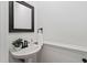 Updated powder room with pedestal sink and elegant fixtures at 2900 Old Trafford Way, Raleigh, NC 27606