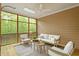 Cozy screened-in porch with comfortable seating and views of the wooded landscape at 2900 Old Trafford Way, Raleigh, NC 27606