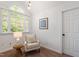 Cozy sitting room with accent lighting, a reading chair, and natural light at 2900 Old Trafford Way, Raleigh, NC 27606