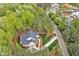 Stunning aerial view of home nestled among lush green trees and professionally landscaped yard at 30 Mist Wood Ct, Pittsboro, NC 27312