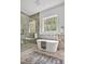 Bright bathroom with soaking tub, glass shower, and modern finishes at 30 Mist Wood Ct, Pittsboro, NC 27312